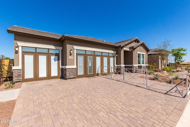 27647 N 176th Dr, Surprise, AZ 85387 - view of front of home with stone siding, stucco siding, and french doors