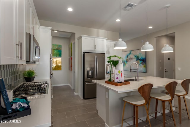27647 N 176th Dr, Surprise, AZ 85387 - kitchen featuring stainless steel appliances, a sink, white cabinets, light countertops, and baseboards