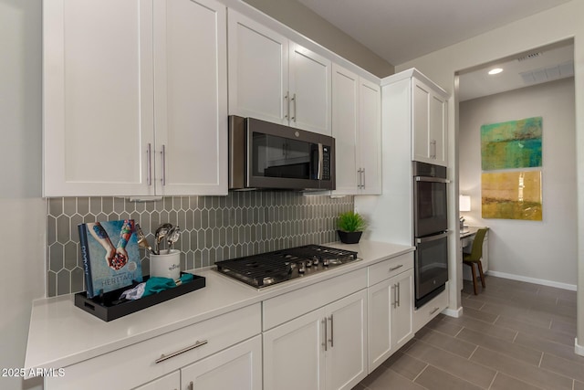 27647 N 176th Dr, Surprise, AZ 85387 - kitchen with stainless steel appliances, decorative backsplash, white cabinets, light countertops, and recessed lighting