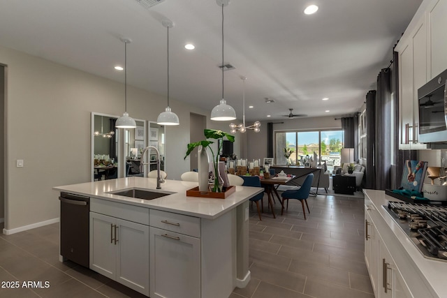 27647 N 176th Dr, Surprise, AZ 85387 - kitchen with a sink, stainless steel appliances, light countertops, recessed lighting, and open floor plan