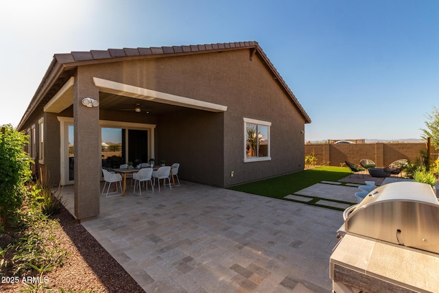27647 N 176th Dr, Surprise, AZ 85387 - back of property featuring a fenced backyard, a patio area, outdoor dining space, and stucco siding