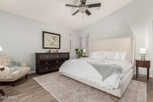 bedroom featuring ceiling fan, wood-type flooring, and vaulted ceiling