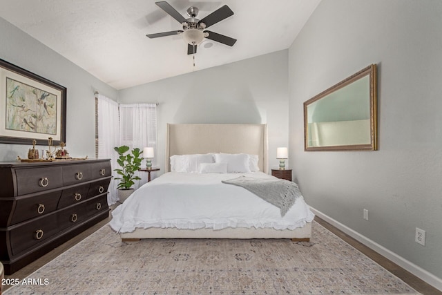 bedroom featuring hardwood / wood-style floors, ceiling fan, and lofted ceiling