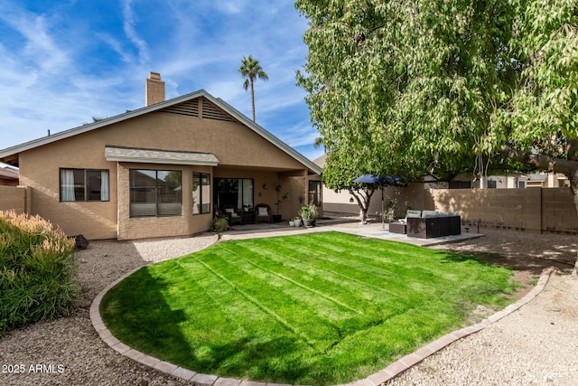 back of property featuring a lawn and a patio area