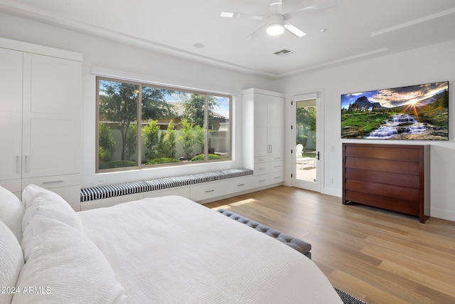 bedroom with access to exterior, ceiling fan, radiator, and light hardwood / wood-style floors