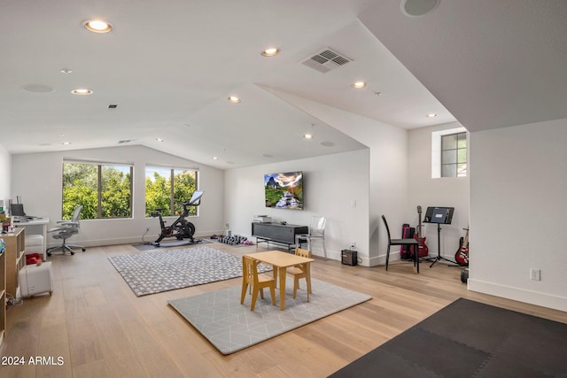 interior space with lofted ceiling and light hardwood / wood-style floors