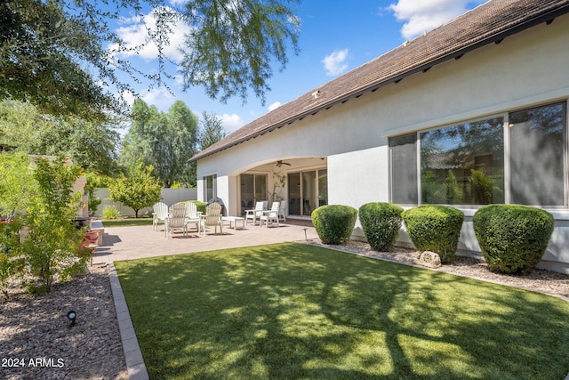 view of yard featuring ceiling fan and a patio area