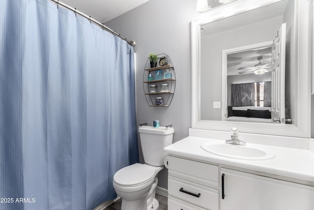 bathroom with ceiling fan, vanity, and toilet