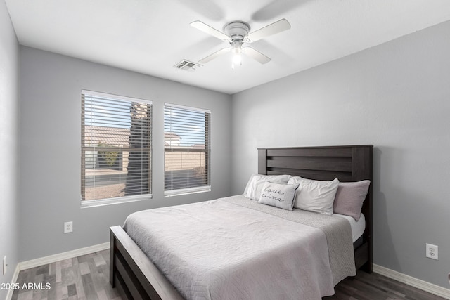 bedroom with dark hardwood / wood-style floors and ceiling fan