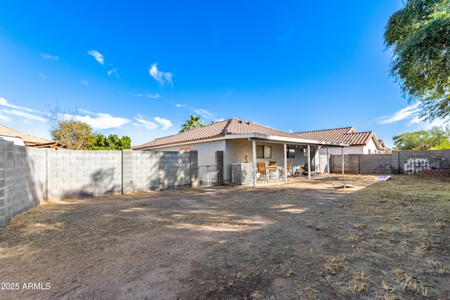 back of house with central AC unit and a patio area