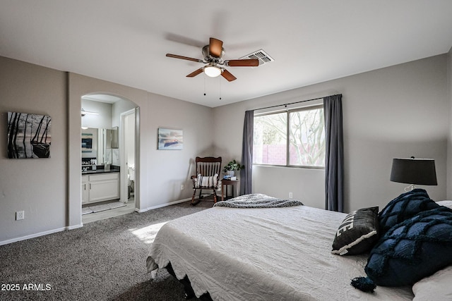 bedroom with ceiling fan, carpet flooring, and ensuite bath