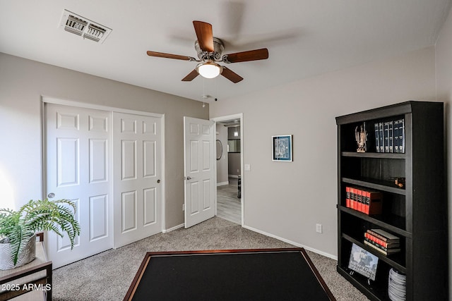 interior space with ceiling fan and carpet flooring