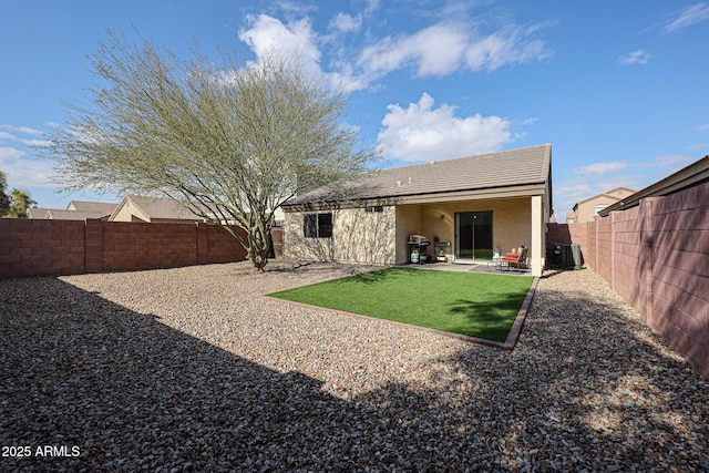 rear view of property with cooling unit and a patio