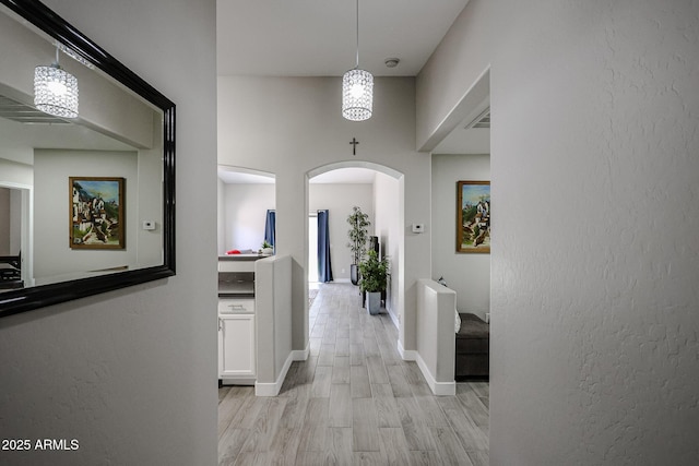 hallway with light hardwood / wood-style floors