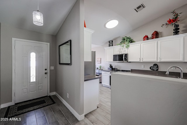 foyer entrance featuring lofted ceiling and sink