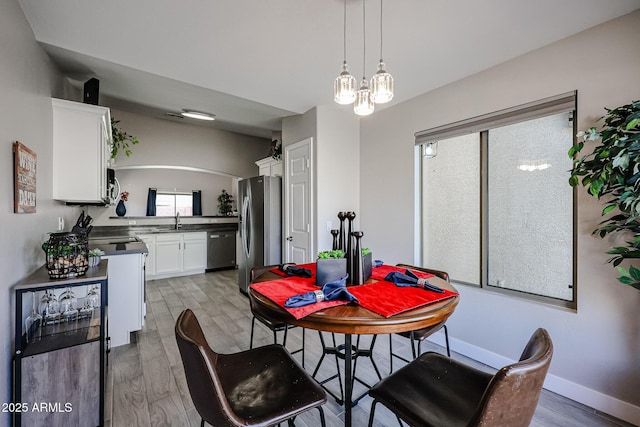 dining room with sink and hardwood / wood-style floors