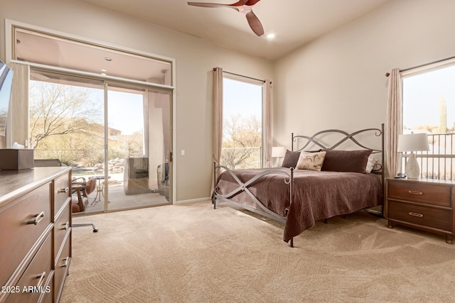 bedroom featuring a mountain view, light carpet, access to exterior, and ceiling fan