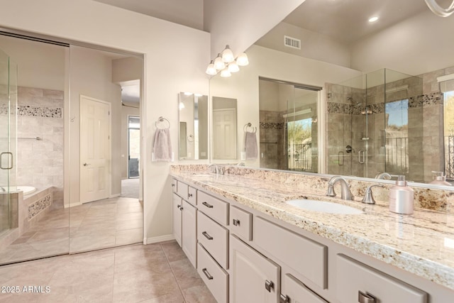 bathroom featuring tile patterned flooring, vanity, and separate shower and tub