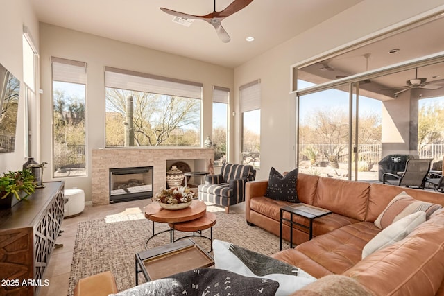 sunroom / solarium featuring a healthy amount of sunlight and ceiling fan