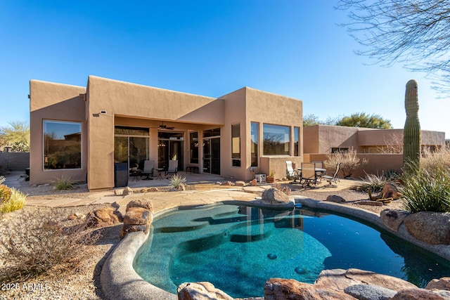 view of pool with ceiling fan and a patio