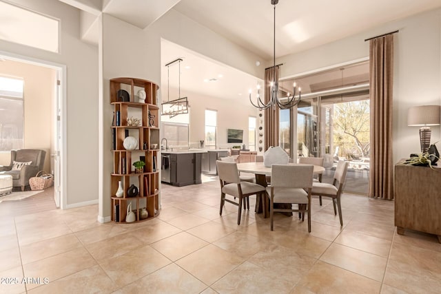 tiled dining space featuring an inviting chandelier, sink, and a healthy amount of sunlight