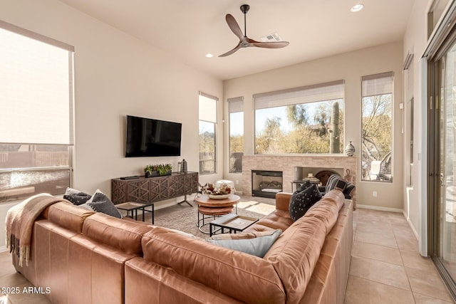 tiled living room with ceiling fan