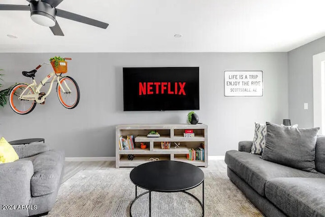 living room with hardwood / wood-style floors and ceiling fan