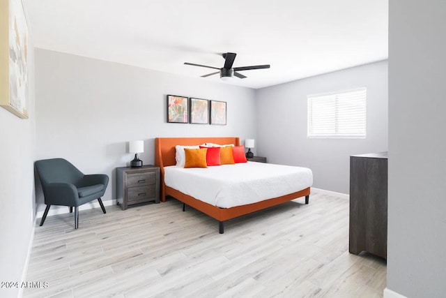 bedroom with light hardwood / wood-style floors and ceiling fan