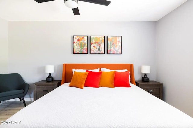 bedroom with hardwood / wood-style floors and ceiling fan