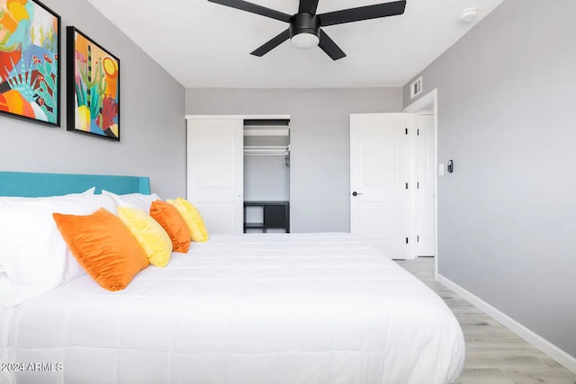 bedroom with ceiling fan, a closet, and light hardwood / wood-style floors