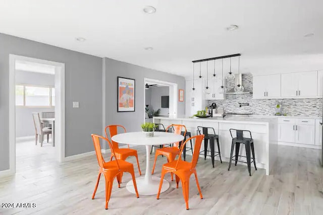 dining area featuring ceiling fan and light hardwood / wood-style floors