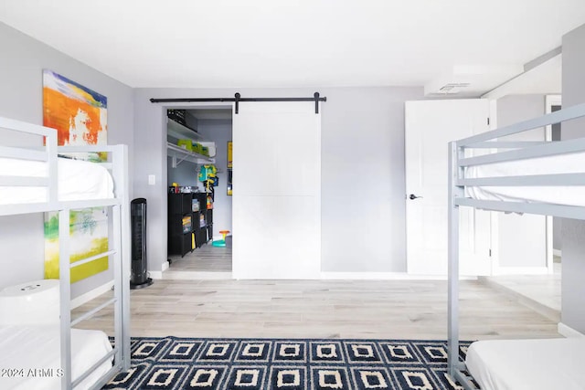 interior space featuring hardwood / wood-style flooring and a barn door