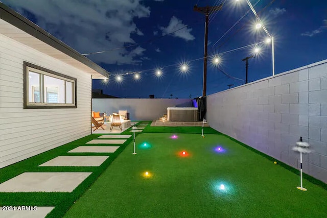 yard at night with central air condition unit, a patio, and an outdoor hangout area