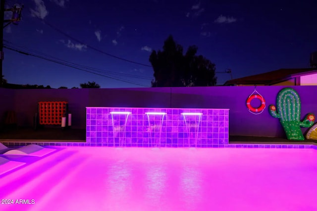 view of pool at night