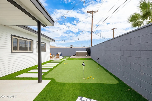 view of yard with a patio and a hot tub