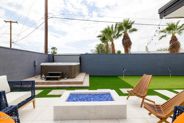 view of patio featuring a hot tub and a fire pit