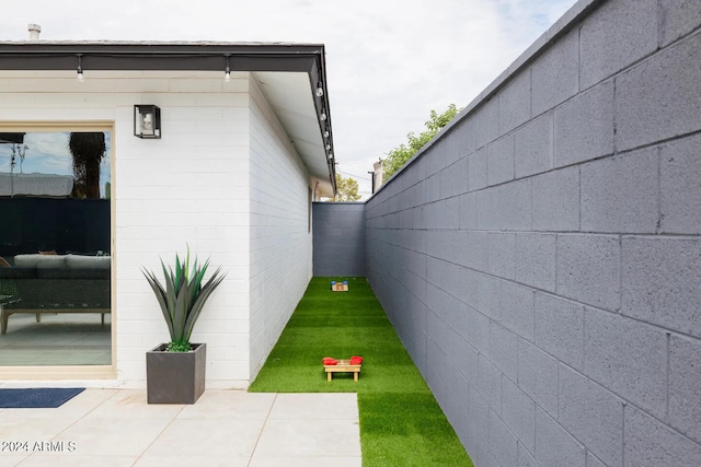 view of side of property featuring a patio area