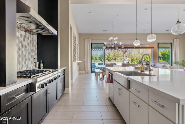 5420 E Duane Ln, Cave Creek, AZ 85331 - kitchen featuring wall chimney range hood, a sink, light countertops, appliances with stainless steel finishes, and healthy amount of natural light