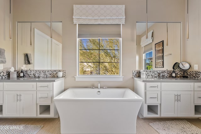 5420 E Duane Ln, Cave Creek, AZ 85331 - bathroom with a freestanding bath, two vanities, backsplash, and wood finished floors