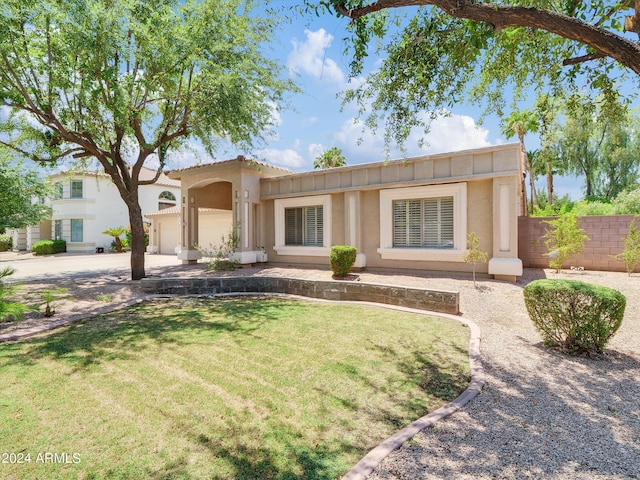 view of front of home featuring a garage and a front lawn