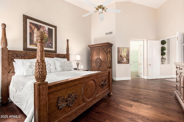 bedroom with dark wood-style flooring, visible vents, baseboards, high vaulted ceiling, and connected bathroom