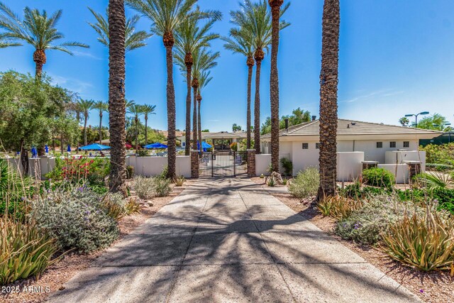 view of road with a gate, a gated entry, and concrete driveway