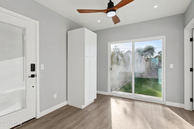 unfurnished bedroom featuring access to exterior, ceiling fan, and light hardwood / wood-style flooring