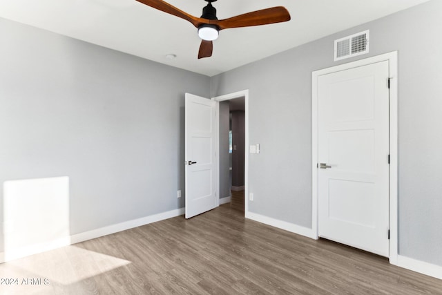 unfurnished bedroom with ceiling fan and hardwood / wood-style floors