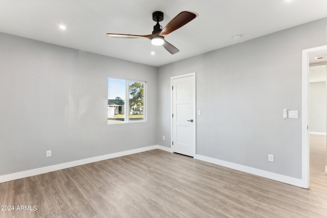 spare room with ceiling fan and light wood-type flooring