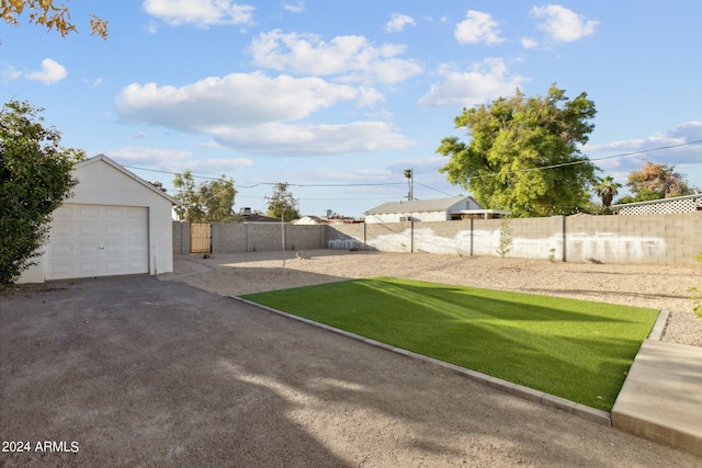 view of yard with an outbuilding and a garage