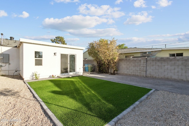 rear view of house featuring a yard