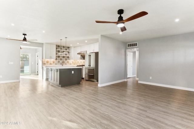 unfurnished living room featuring light hardwood / wood-style flooring and ceiling fan