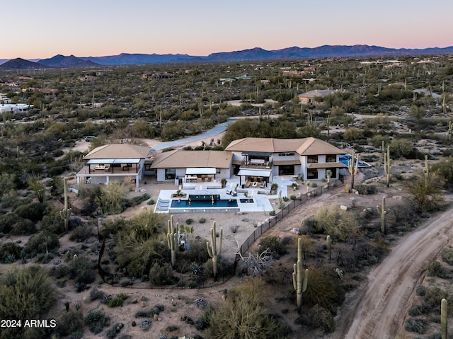 aerial view at dusk featuring a mountain view