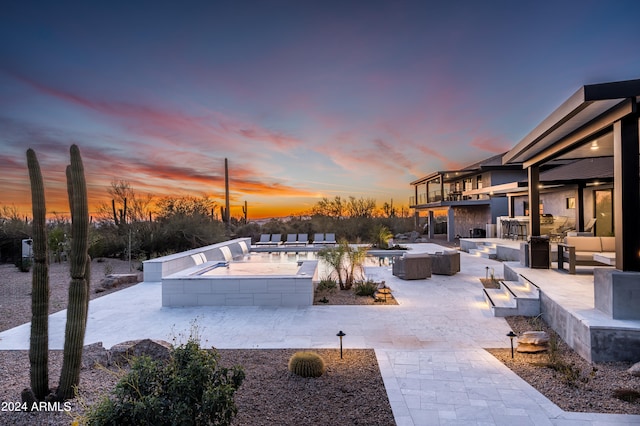 exterior space with a patio area, area for grilling, and an outdoor living space with a fire pit